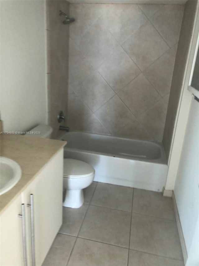 full bathroom with vanity, tile patterned flooring, toilet, and tiled shower / bath