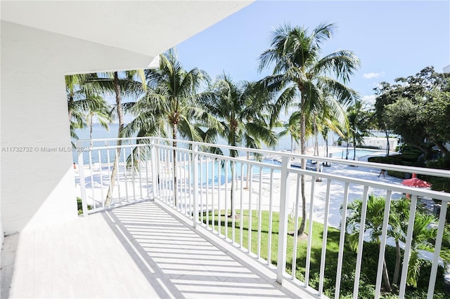 balcony featuring a water view and a beach view