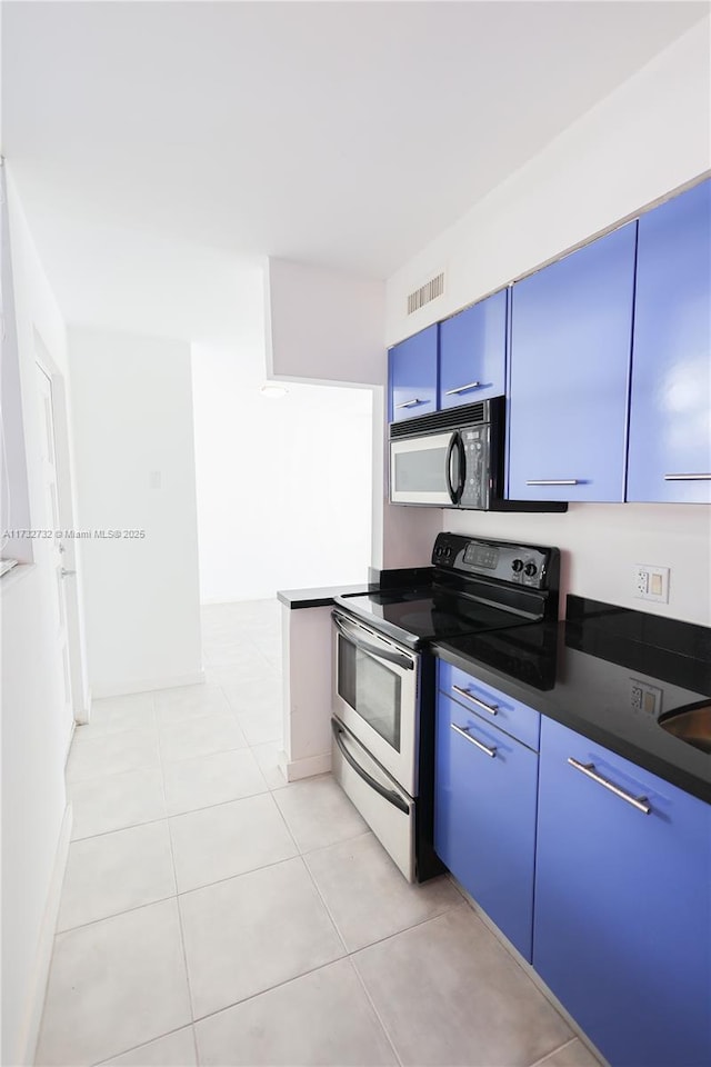 kitchen featuring stainless steel range with electric stovetop, blue cabinetry, sink, and light tile patterned floors