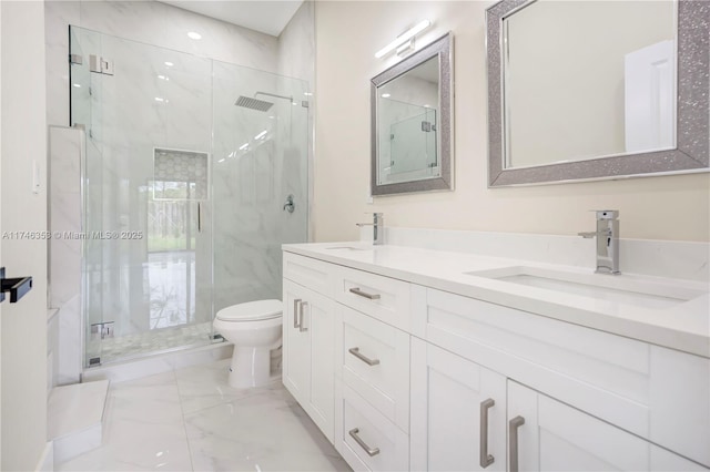 bathroom featuring vanity, toilet, and a shower with shower door