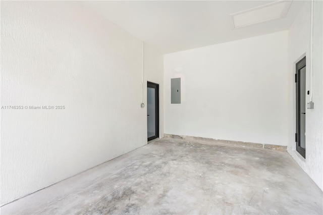 spare room featuring electric panel and concrete floors