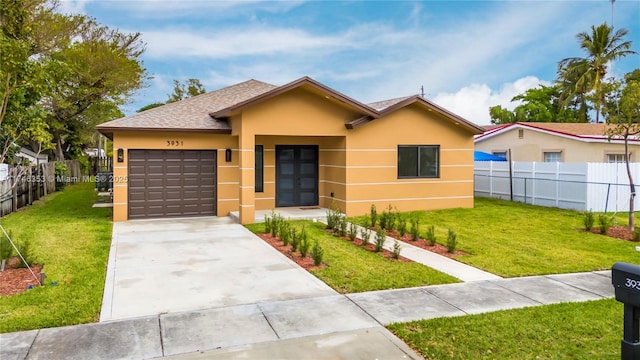 view of front of property featuring a front lawn and a garage