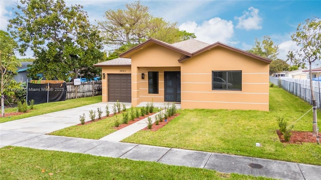 view of front of property with a front lawn and a garage