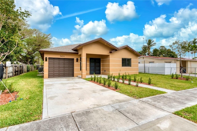 view of front of house featuring a front lawn and a garage