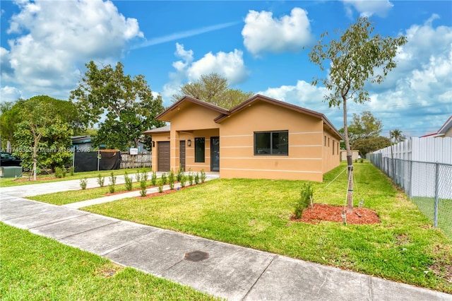 bungalow-style house with a front yard and a garage