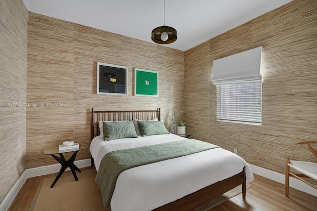 bedroom with wood-type flooring