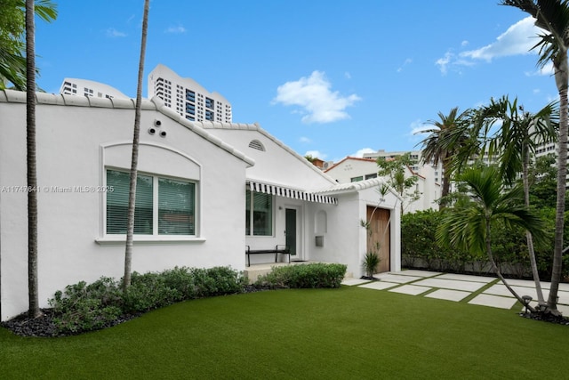 rear view of house featuring a lawn