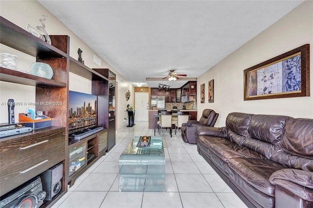 tiled living room featuring ceiling fan