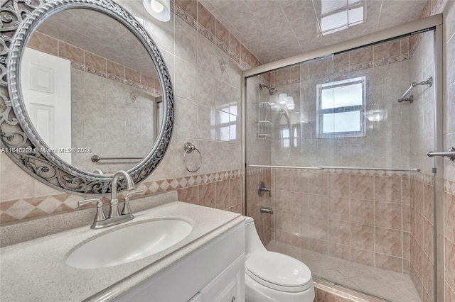 bathroom featuring toilet, walk in shower, tile walls, decorative backsplash, and vanity