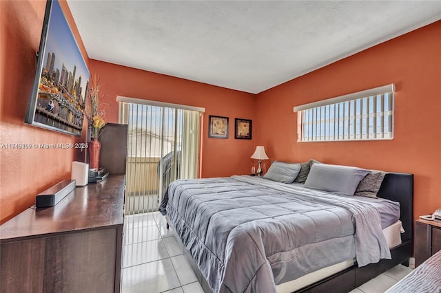 bedroom with multiple windows and light tile patterned floors