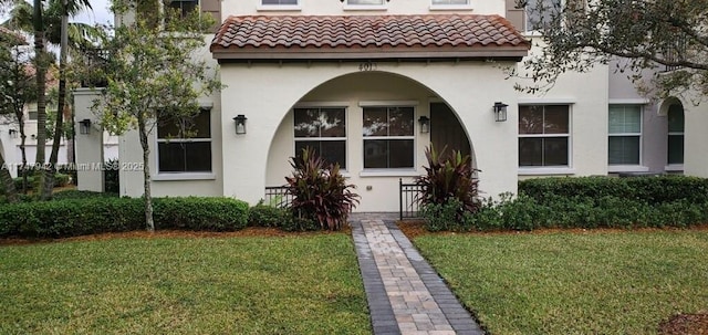 entrance to property featuring a lawn