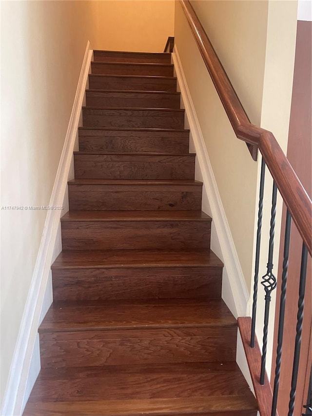 staircase with hardwood / wood-style flooring