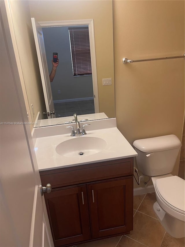 bathroom featuring tile patterned floors, toilet, and vanity