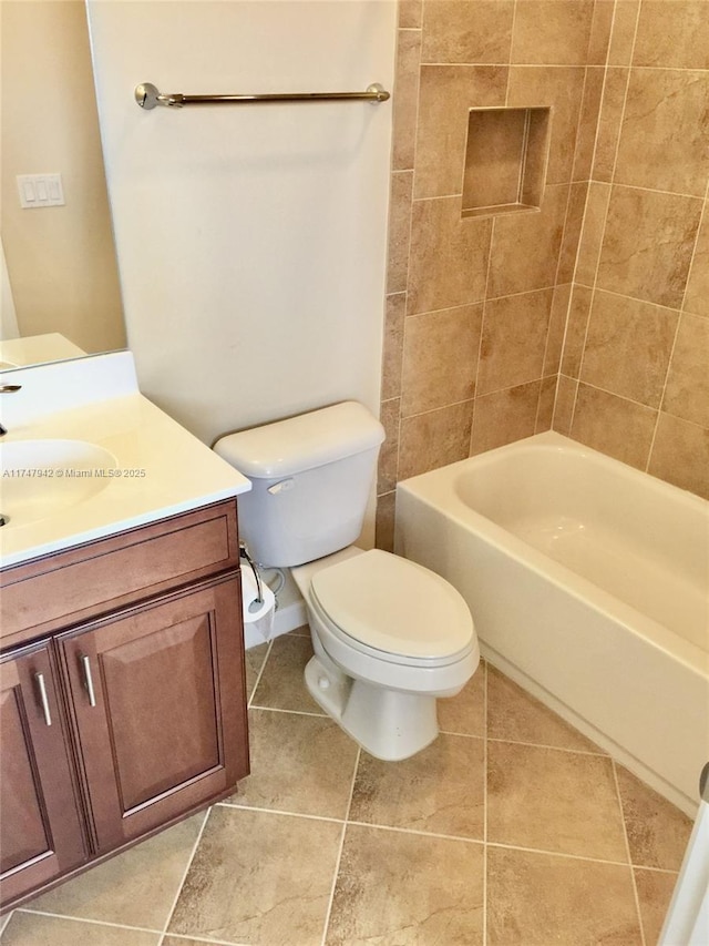 full bathroom featuring toilet, tile patterned flooring, vanity, and tiled shower / bath