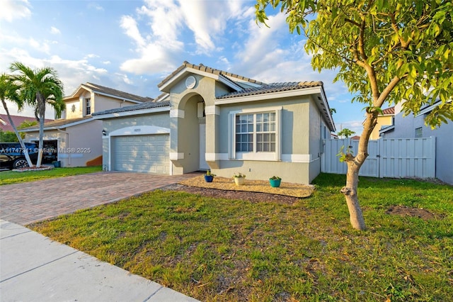 view of front of property featuring a garage and a front lawn