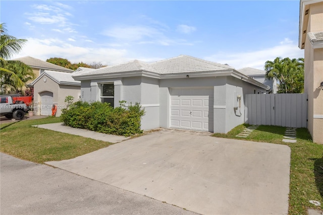 view of front of property featuring an attached garage, a tiled roof, concrete driveway, and stucco siding