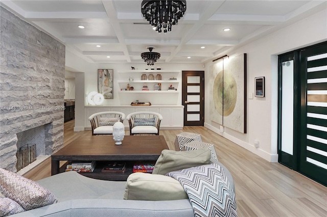 living room featuring coffered ceiling, beam ceiling, a fireplace, and light hardwood / wood-style flooring