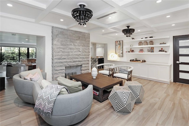 1301 Adams St, Hollywood, FL 33019 - living room featuring a fireplace, light hardwood / wood-style floors, and a chandelier