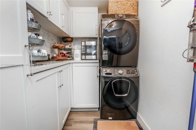 1301 Adams St, Hollywood, FL 33019 - laundry area with cabinets, stacked washer / drying machine, and light hardwood / wood-style floors