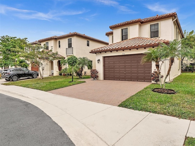 mediterranean / spanish house with a front lawn and a garage