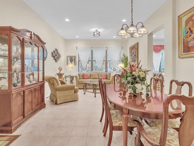 tiled dining room featuring a chandelier