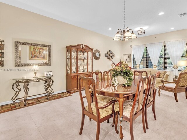 dining area featuring a notable chandelier