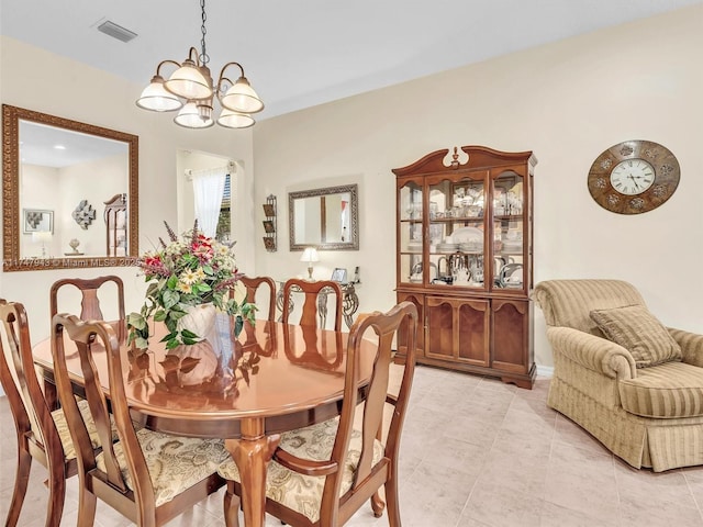 tiled dining space featuring a notable chandelier