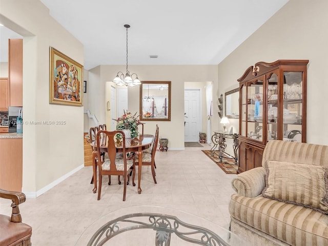 tiled dining space featuring a chandelier