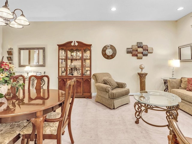 living room with a notable chandelier and light tile patterned flooring