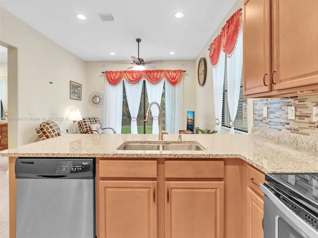 kitchen with kitchen peninsula, stainless steel appliances, sink, backsplash, and ceiling fan