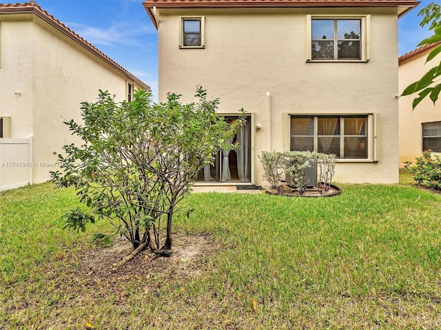 rear view of property featuring a yard