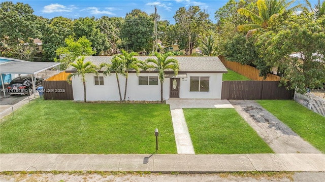 view of front facade featuring a front yard and a carport