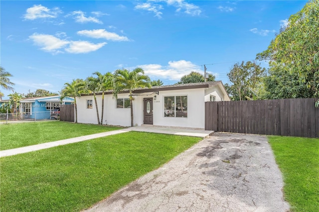 ranch-style home with a front yard