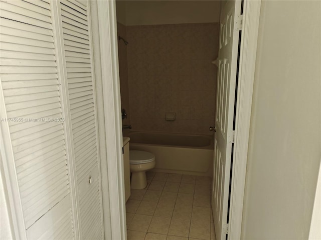 full bathroom with a closet, shower / tub combination, toilet, and tile patterned floors