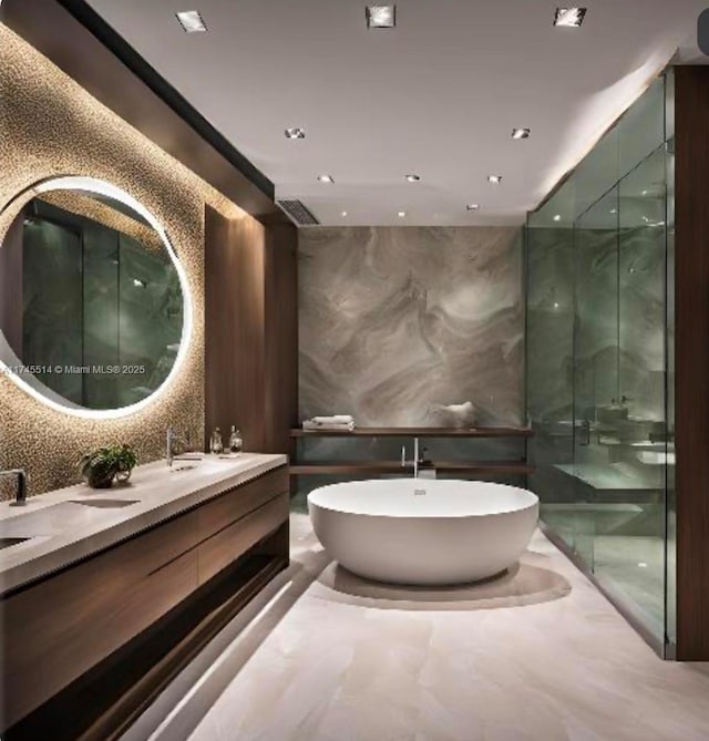 bathroom with a soaking tub, a shower stall, marble finish floor, and double vanity