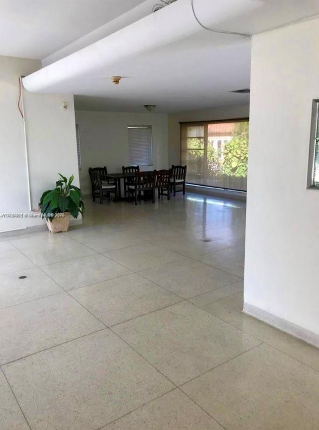 unfurnished dining area featuring baseboards