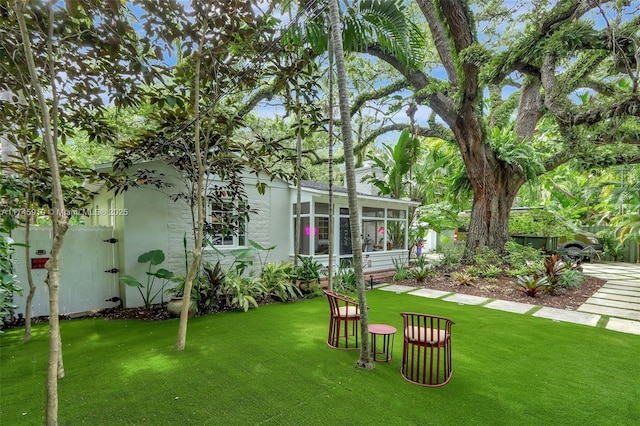 view of yard featuring a sunroom