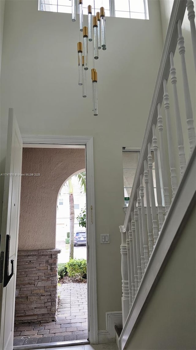 entrance foyer with a high ceiling and stairway