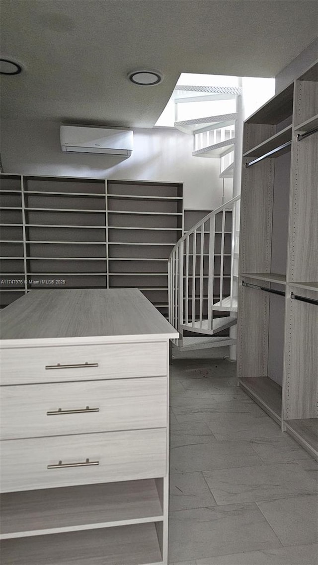 spacious closet featuring a wall mounted AC