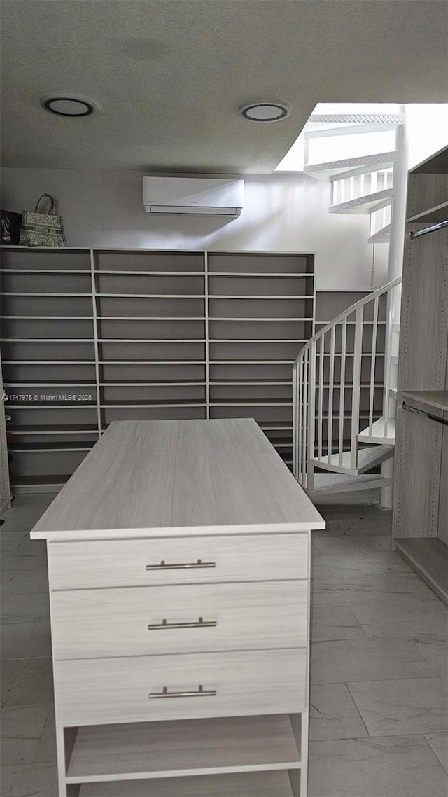 spacious closet with an AC wall unit