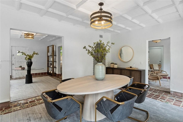 dining area featuring beamed ceiling, a notable chandelier, and coffered ceiling