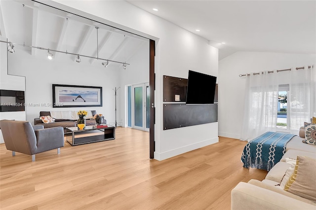 living room featuring high vaulted ceiling, recessed lighting, light wood-style flooring, and baseboards