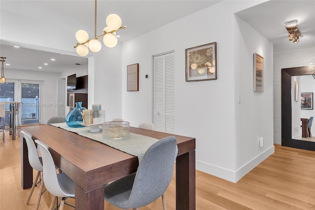 dining area with light wood finished floors, baseboards, and recessed lighting