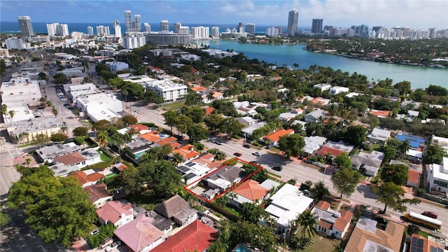 birds eye view of property with a water view and a city view