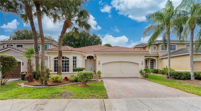 mediterranean / spanish-style home with a front lawn and a garage