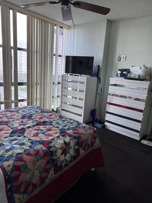 bedroom featuring ceiling fan and a textured ceiling