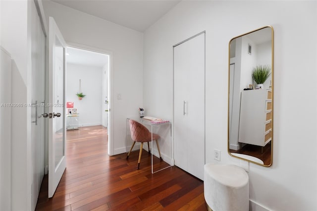 corridor with dark hardwood / wood-style flooring