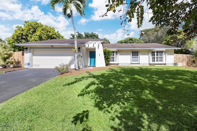 single story home featuring fence, a garage, a front lawn, aphalt driveway, and stucco siding