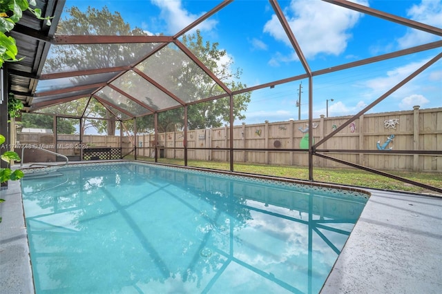 view of swimming pool featuring a lanai