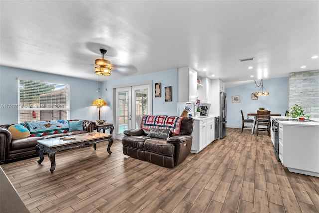 living room with light wood-type flooring and french doors